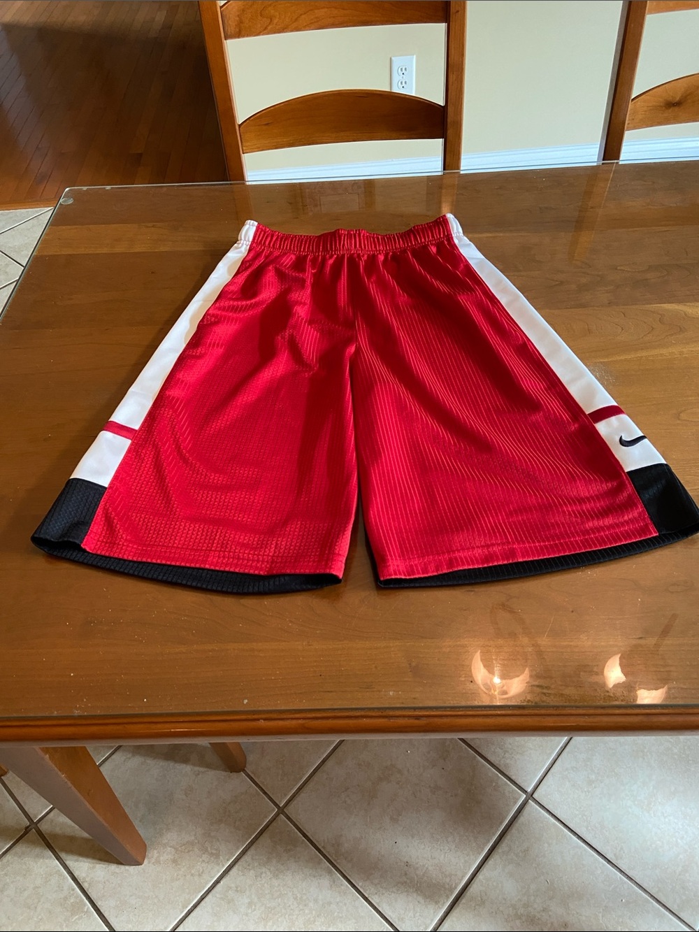 Nike Red Athletic Shorts with White Side Panels and Black Hem. Young Men.